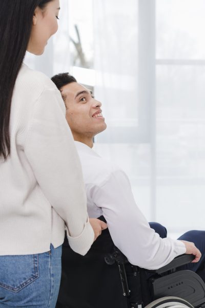 close-up-woman-helping-disabled-woman-wheelchair
